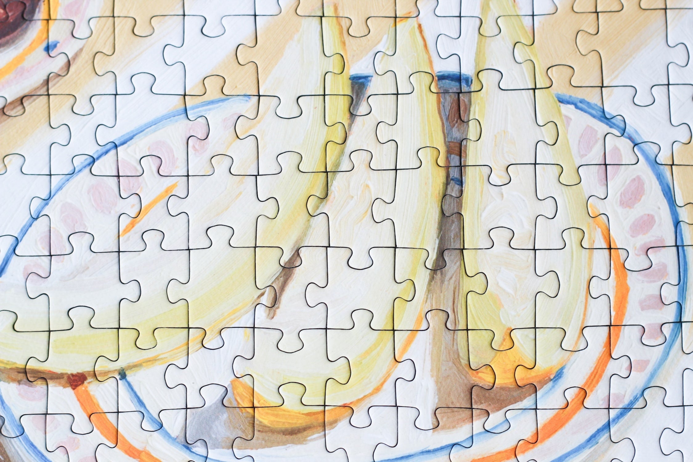 500-teiliges Puzzle für Erwachsene, das eine Frau beim Picknicken von Trauben, Feigen, Melone und Champagner zeigt.