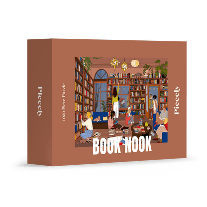 1000-Teile-Puzzle „Book Nook“ von Piecely – Illustration einer gemütlichen Bibliothek mit Bücherregalen, Lesenden und warmem Licht, auf brauner Verpackung.
