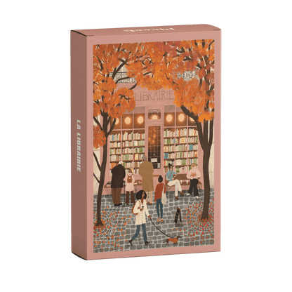 99-Teile-Mini-Puzzle „La Librairie“ von Piecely – Illustration einer herbstlichen Straßenszene vor einer Pariser Buchhandlung, auf rosafarbener Verpackung.