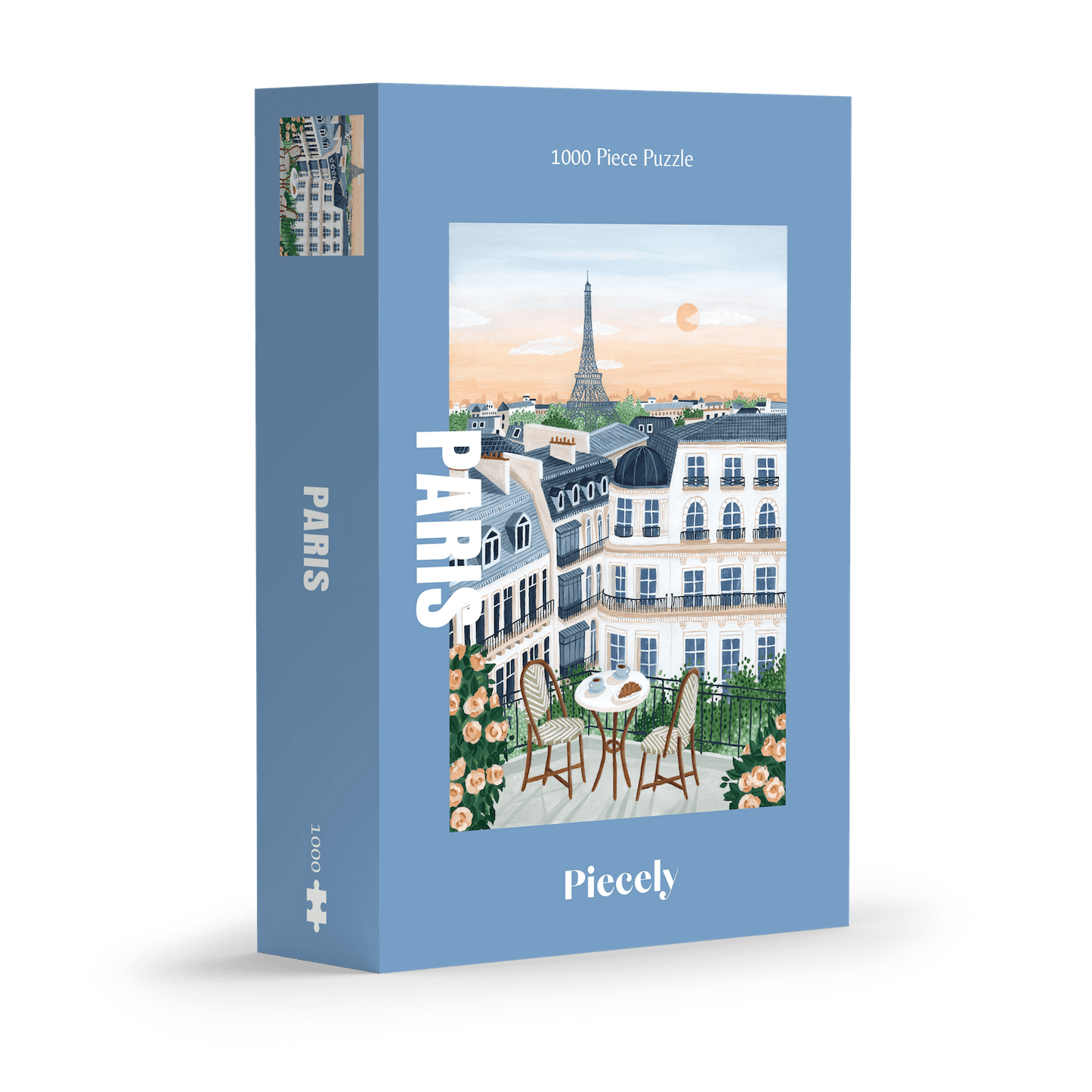 1000-Teile-Puzzle „Paris“ von Piecely – Illustration eines Pariser Balkons mit Frühstückstisch und Blick auf den Eiffelturm, auf hellblauer Verpackung.
