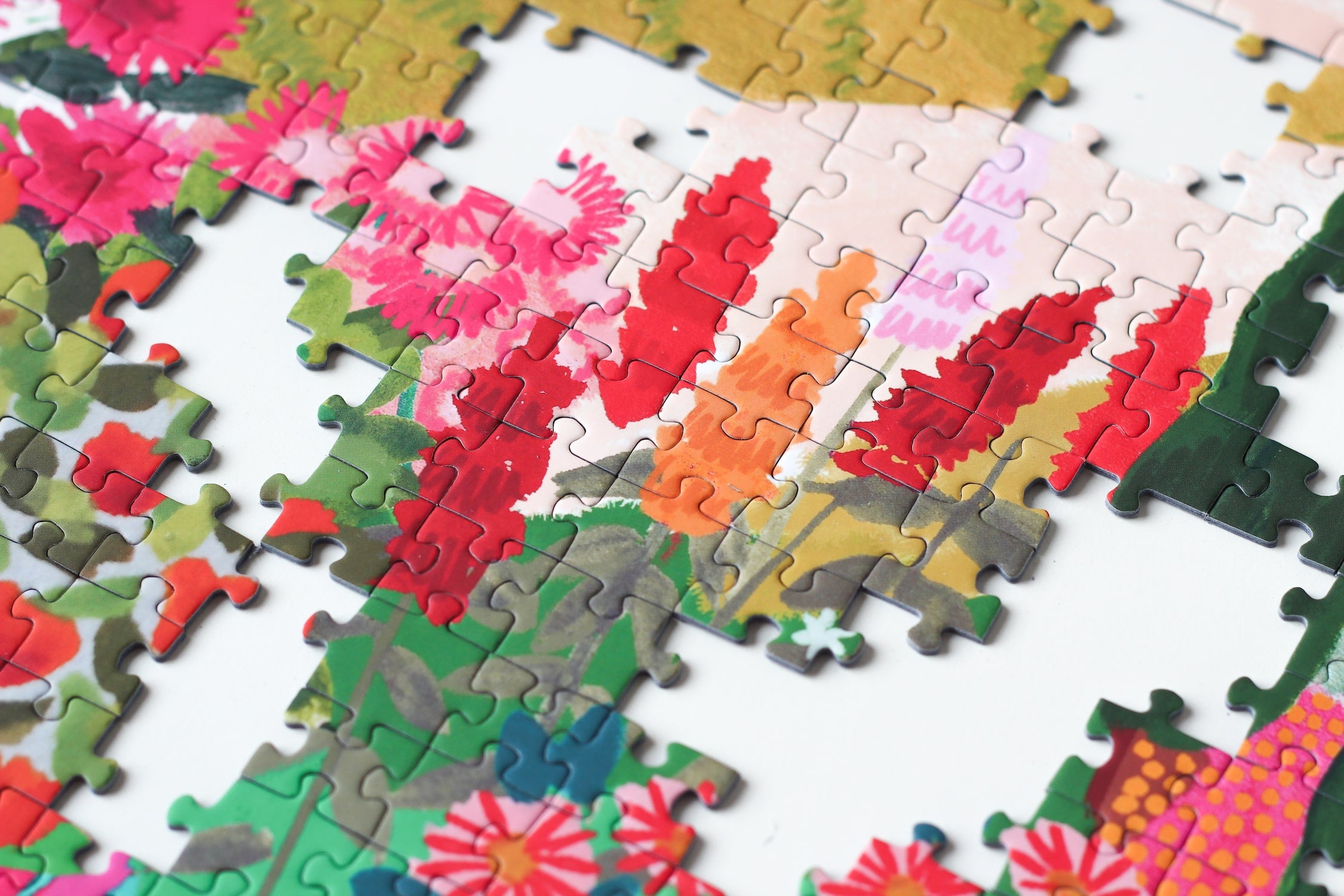 Außergewöhnliches 1000-Teile-Puzzle für Erwachsene, das die sommerliche Landschaft Apuliens in Italien zeigt. Zu sehen sind blühende Felder, Ein Berg und ein kleines Haus.