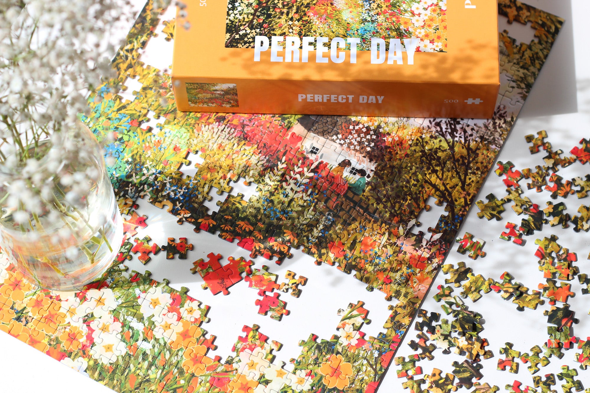 Nachhaltiges Perfect Day Puzzle, das einen herbstlichen Wald mit blühenden Blumen und einem Pärchen, das picknickt, zeigt