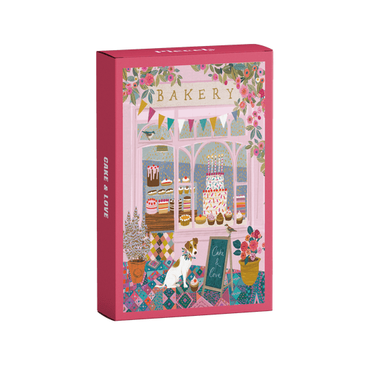 Plastikfreies Minipuzzle für Erwachsene, das eine rosa Bäckerei mit Torten und Cupcakes im Schaufenster und einen Hund vor der Tür zeigt.
